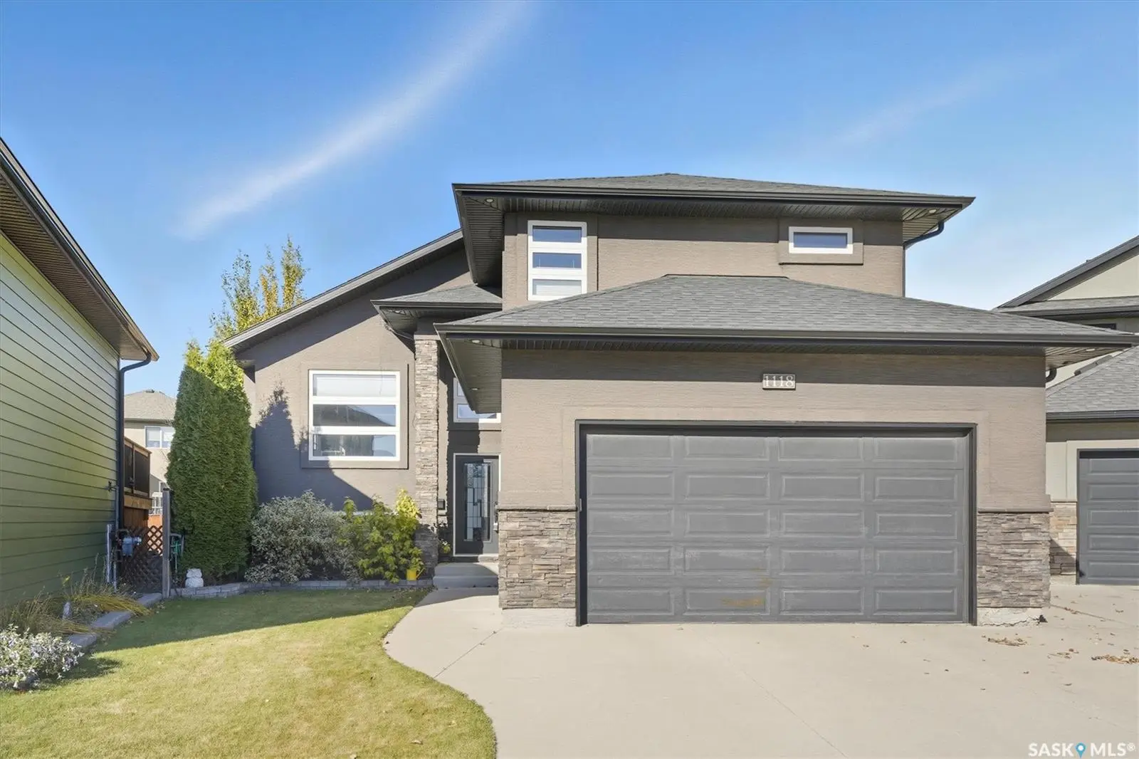 Exterior photo of 1118 Rempel Place, Saskatoon SK — modern bi-level home with heated double garage in Stonebridge.